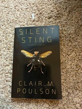 Silent Sting by Clair M. Poulson - Black Cover with Gold Insect Accent